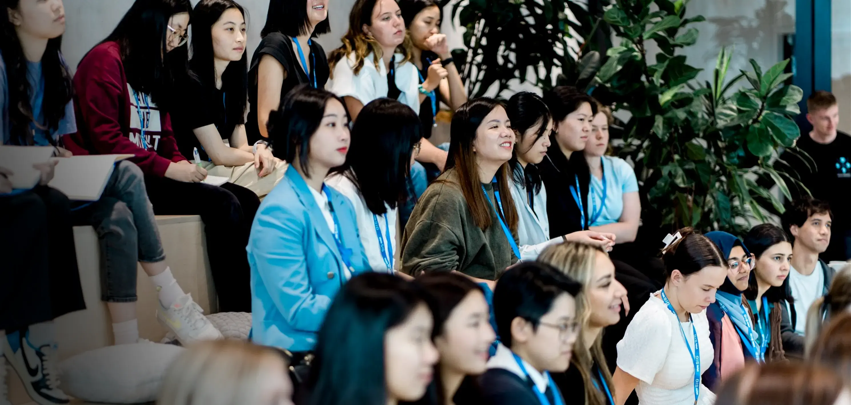 A large group of college students sitting in stadium steaing